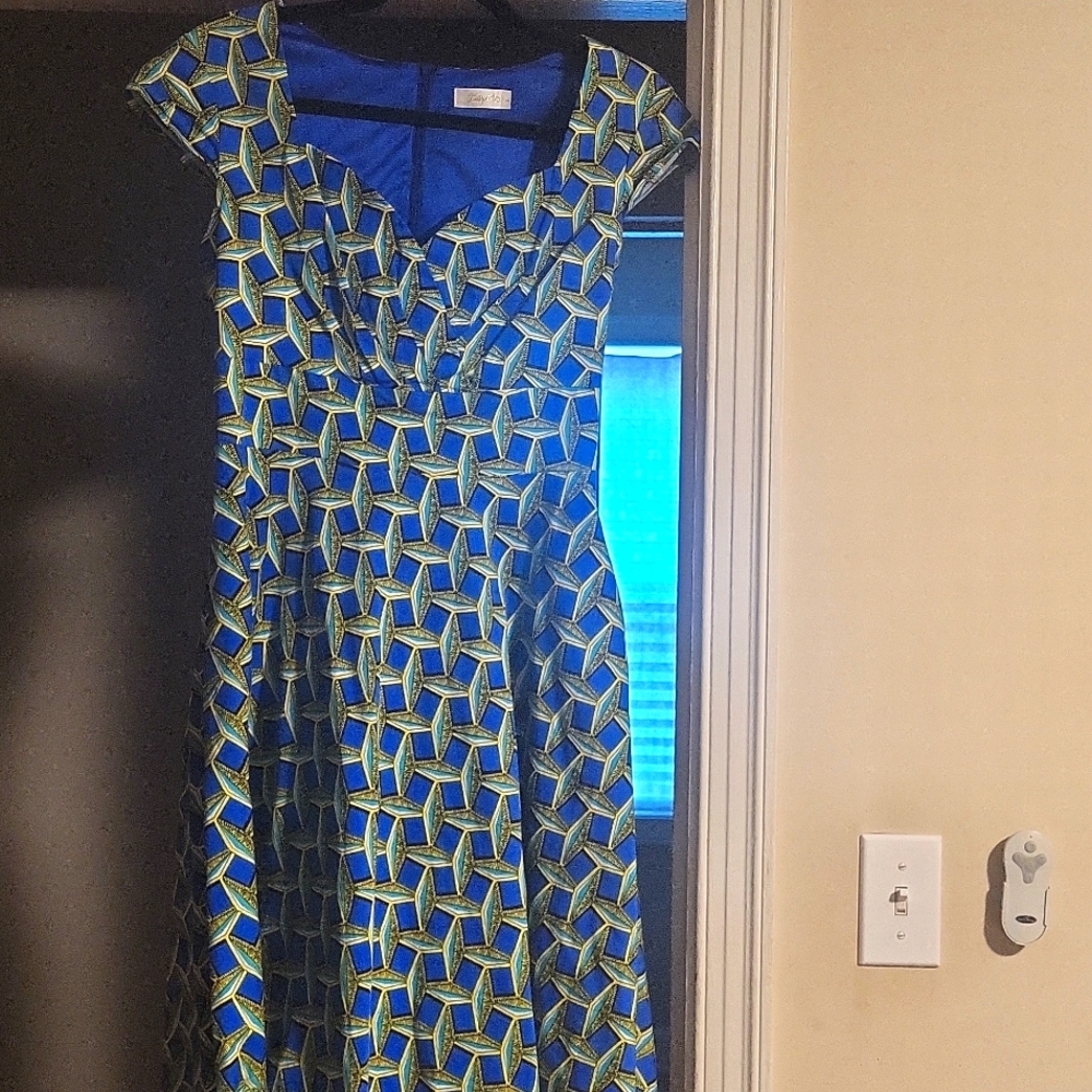 A patterned blue, turquoise,  yellow & black dress.